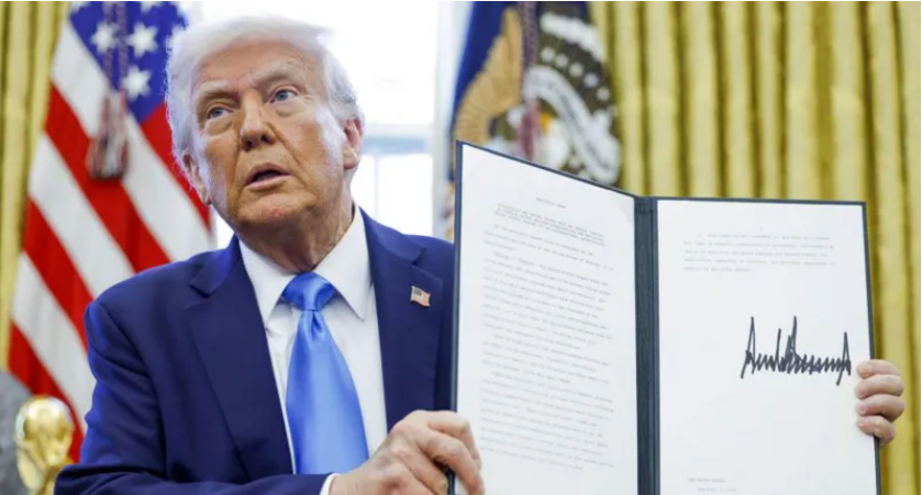 Trump displays a newly signed executive order.