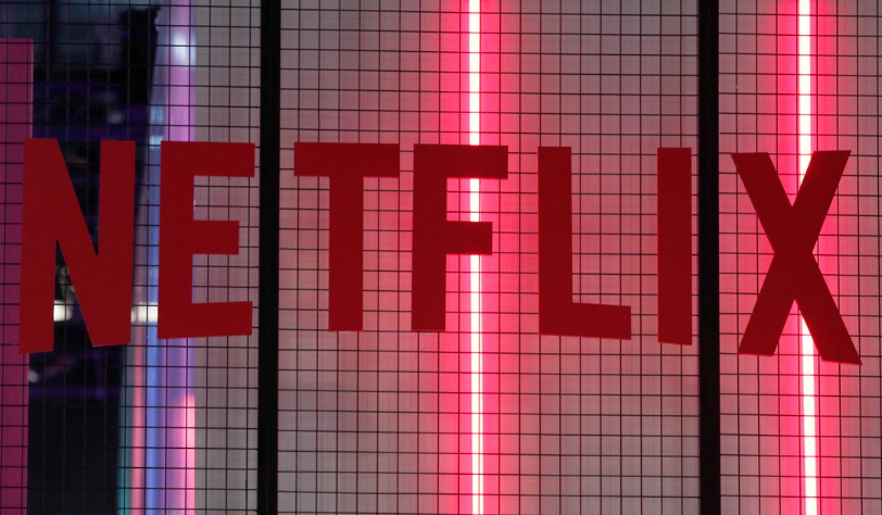 Netflix app displayed on a smart TV screen alongside an iPhone showing the Netflix interface.