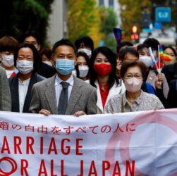 Plaintiffs and supporters outside the Tokyo courthouse holding protest signs after the high court upholds Japan’s same-sex marriage ban.