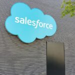 Salesforce logo on building with cybersecurity warning graphics representing investigation into potential customer data exposur