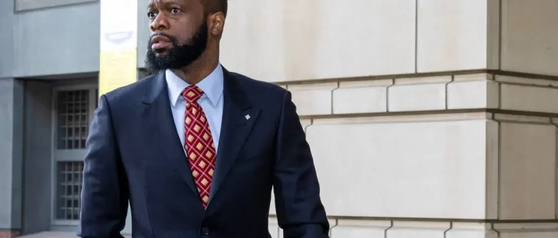 Pras Michel walking out of a U.S. courthouse after receiving a 14-year prison sentence for illegally funneling foreign money into the 2012 Obama campaign.