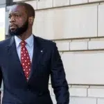 Pras Michel walking out of a U.S. courthouse after receiving a 14-year prison sentence for illegally funneling foreign money into the 2012 Obama campaign.