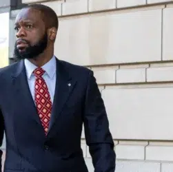 Pras Michel walking out of a U.S. courthouse after receiving a 14-year prison sentence for illegally funneling foreign money into the 2012 Obama campaign.