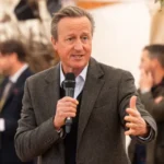 David Cameron speaking at a public event after revealing his recent prostate cancer diagnosis and treatment