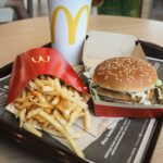 McDonald’s restaurant in Brazil decorated like the Upside Down from Stranger Things with retro arcade lights and themed menu.