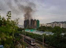 Flames engulfing multiple high-rise apartments in Hong Kong’s Wang Fuk Court, with residents watching from a safe distance as firefighters battle the blaze.