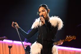 British singer Olivia Dean performing live as news emerges that Ticketmaster will refund fans and cap resale prices following her criticism of inflated ticket costs.