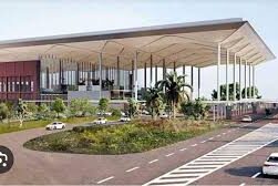 Aerial view of Yamuna Expressway near the upcoming Jewar Airport, with developing real estate projects and vacant land parcels.