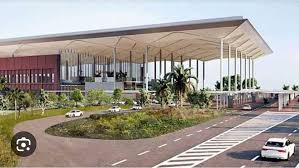 Aerial view of Yamuna Expressway near the upcoming Jewar Airport, with developing real estate projects and vacant land parcels.