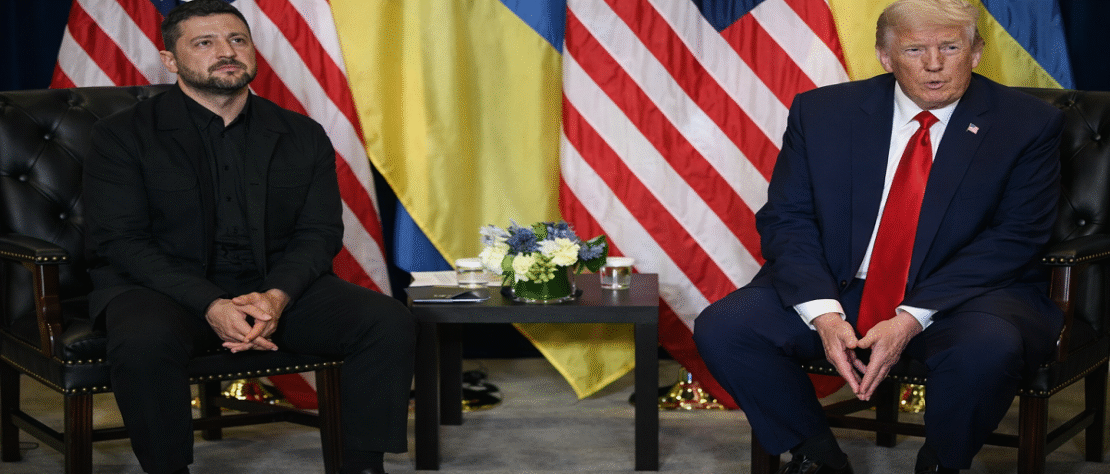 Air defense systems firing at incoming missiles over Kyiv during a nighttime drone and missile attack, with city lights visible below.