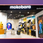 Mokobara luggage and travel accessories displayed, showcasing sleek, minimalist design, vibrant interiors, and premium features like reinforced shells and Japanese wheels.