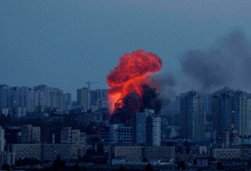 Emergency responders at a warehouse in Kyiv damaged by Russian drone and missile attacks during overnight strikes across Ukraine.