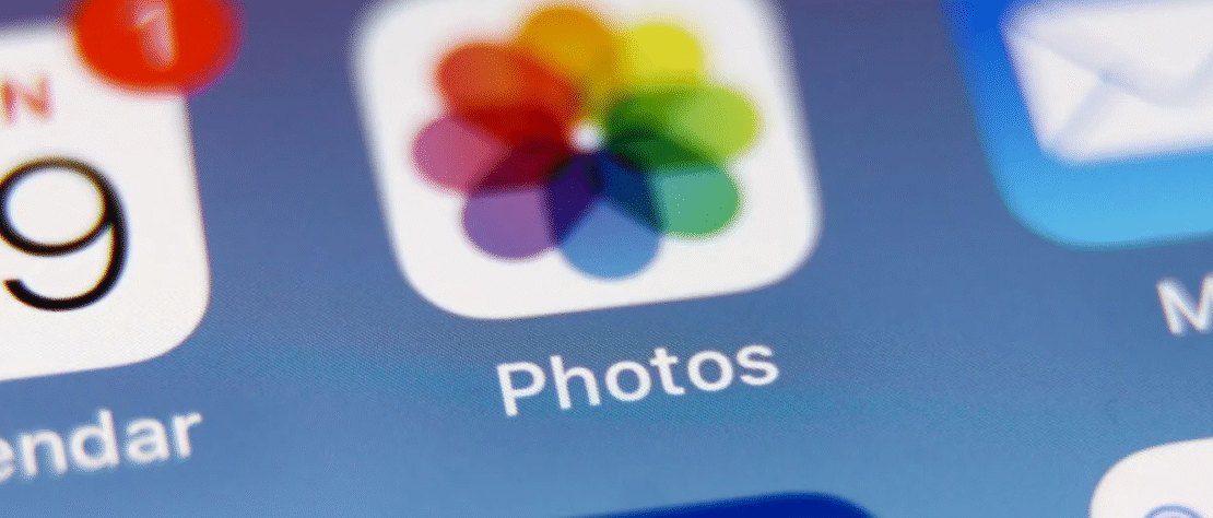 iPhone showing a red-tinted photo in the Photos app due to an iOS 26 bug affecting images taken on Android devices.