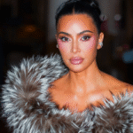 Kim Kardashian attending a high-profile fashion event, known for her work as a media personality, entrepreneur, and founder of Skims.