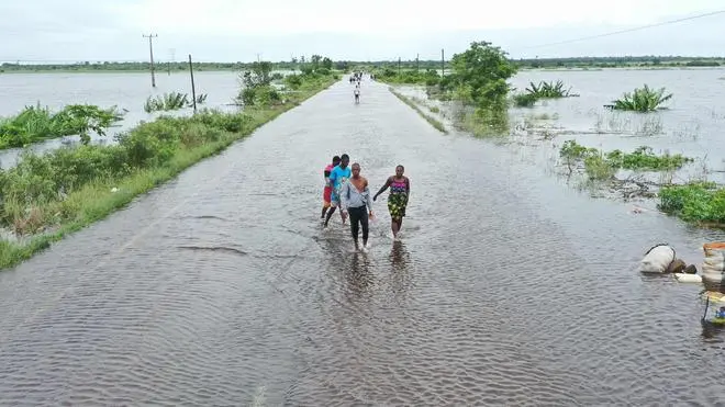 People wading through chest-deep floodwaters in Xai-Xai, Mozambique, January 2026.