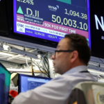 Traders on the New York Stock Exchange celebrate as the Dow Jones Industrial Average crosses 50,000