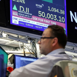 Traders on the New York Stock Exchange celebrate as the Dow Jones Industrial Average crosses 50,000